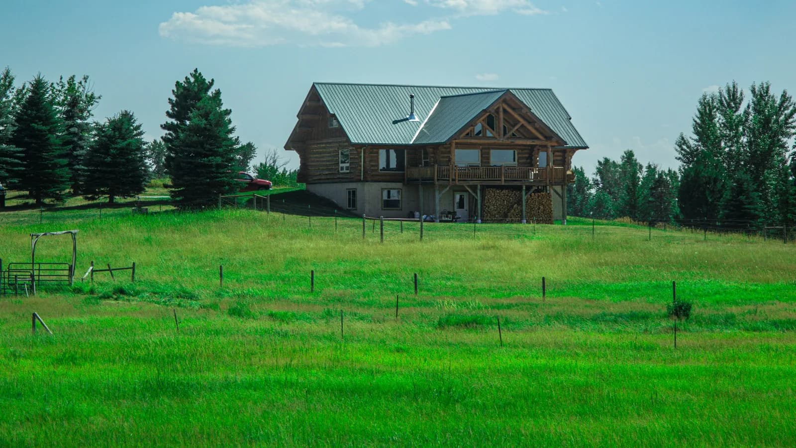 A rural home bordered by meadow and trees